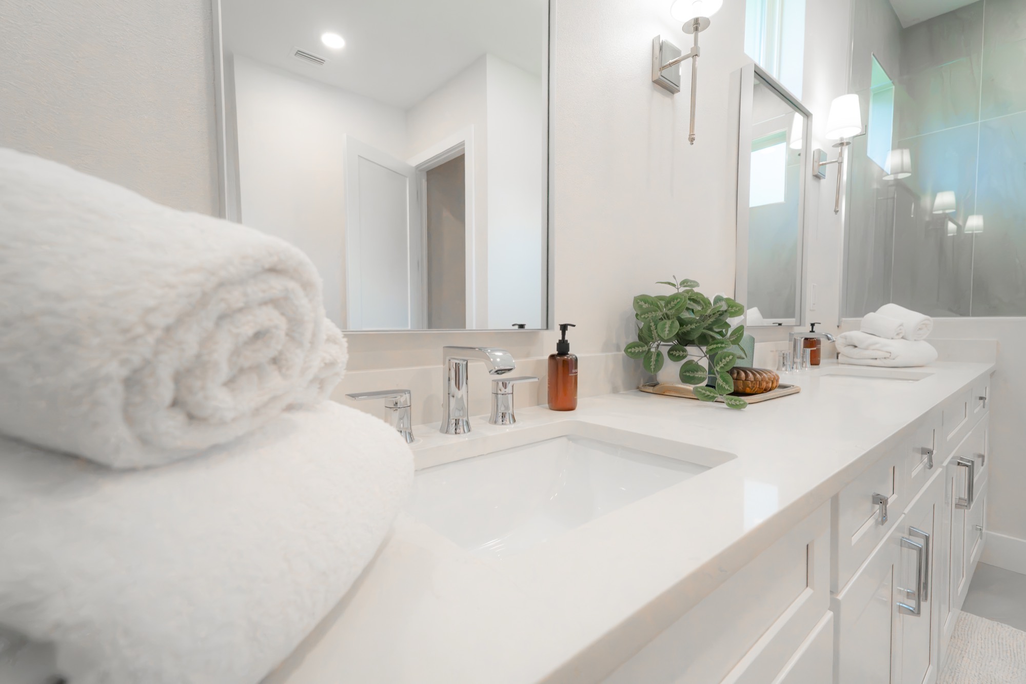 Fresh rolled towels on a polished bathroom counter